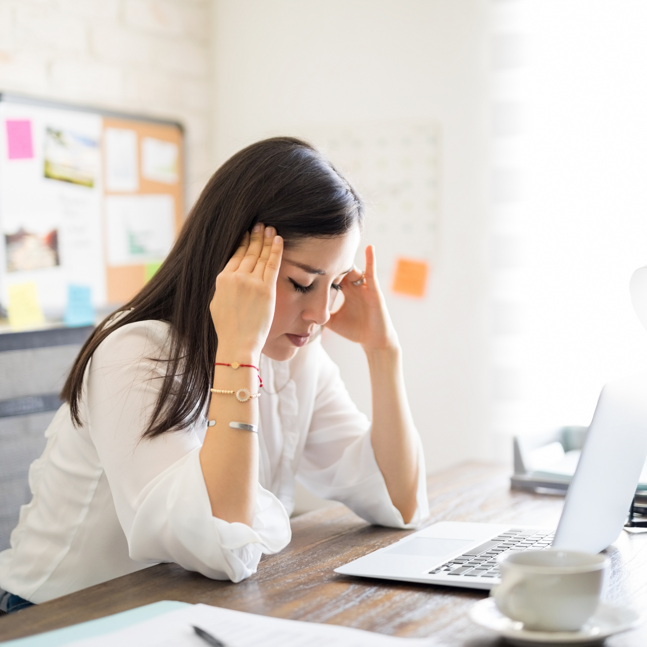 Woman with Hands on Her Head at the Office