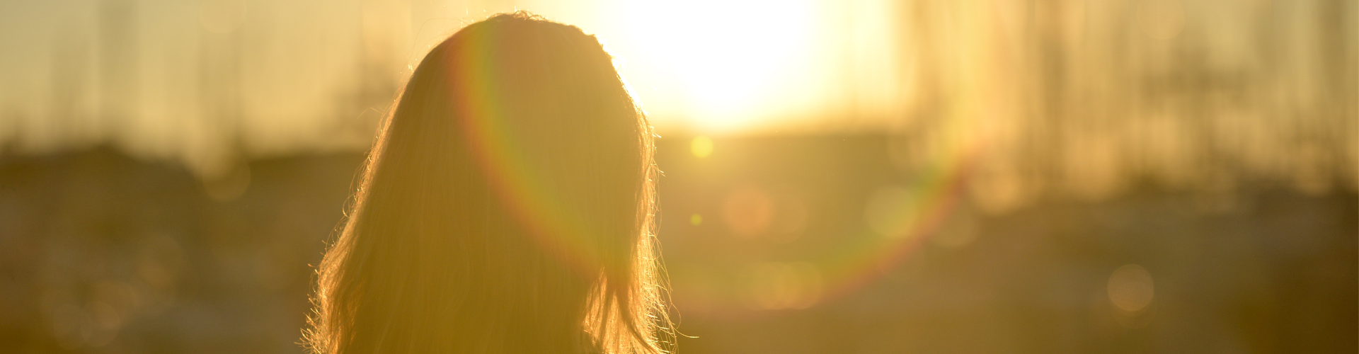 Woman Standing Against Facing Sun
